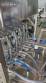 Complete filling line with Tecman Nelpas Tecnoenvase Tudela bottle filling, labeling, capping, and positioning machines for cosmetic liquids.