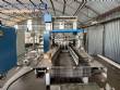 Automatic baling machine with shrink tunnel for bottles and jars in bales.