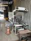 Automatic baling machine with shrink tunnel for bottles and jars in bales.