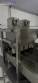 Automatic stainless steel deep fryer for donuts and cream puffs.