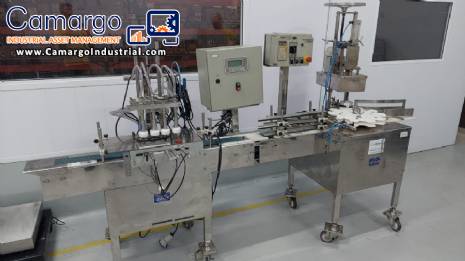 Linear filling machine with 4 stainless steel screw-on nozzles for bottles.