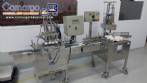 Linear filling machine with 4 stainless steel screw-on nozzles for bottles.