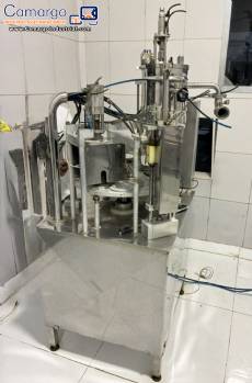 Mirainox rotary carousel filling and dosing machine with automatic sealer for liquids and semi-viscous products in cups.