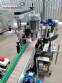 Automatic labeler for flat bottles