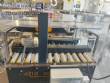 Adhesive tape case sealer with safety enclosure and door sensors Strapack