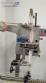 Label applicator machine with steam-operated shrink tunnel for sleeves.