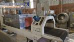 Labeling machine with steam sleeve tunnel and bottle baler