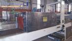 Labeling machine with steam sleeve tunnel and bottle baler