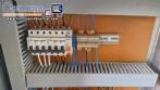 Labeling machine with steam sleeve tunnel and bottle baler