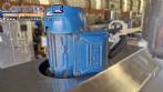 Labeling machine with steam sleeve tunnel and bottle baler