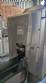 Labeling machine with steam sleeve tunnel and bottle baler