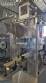 Labeling machine with steam sleeve tunnel and bottle baler