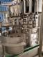 Zegla rotary filling machine with rinser and three-block capping system.