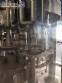 Zegla rotary filling machine with rinser and three-block capping system.