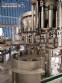 Zegla rotary filling machine with rinser and three-block capping system.
